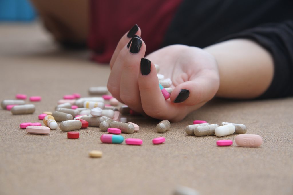 Picture of a person using prescription pills.